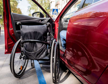 Young handicapped man on drivers seat of his carの写真素材