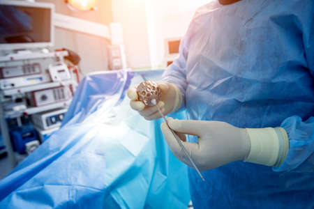 Surgeon performs endoscopic microdiscectomy of herniated intervertebral disc.の写真素材