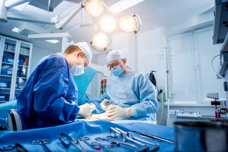 Surgeons in the operating room trying to save the patients hand.の写真素材