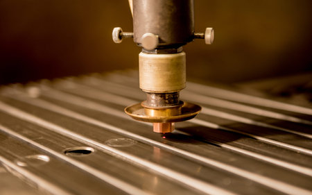 The laser cutting machine cutting the holes on pipes