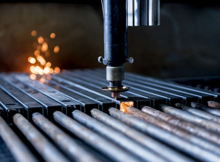 The laser cutting machine cutting the holes on pipesの写真素材