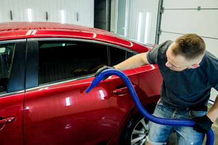 Service worker makes automatic drying of the car after washing.
