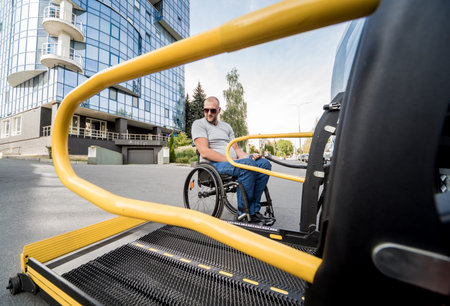 A man in a wheelchair moves to the lift of a specialized vehicle
