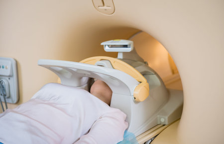 Radiologist prepares the young woman for an MRI brain examination