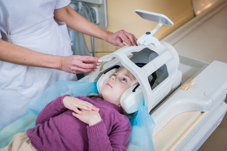 Radiologist prepares the little girl for an MRI brain examinationの写真素材