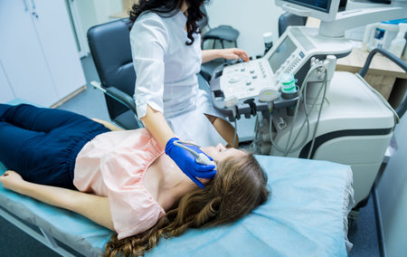 Doctor using ultrasound scanning machine for examining a head of woman