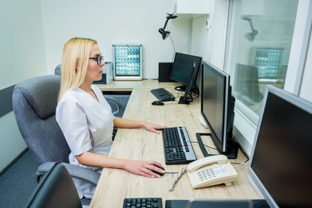 Radiologist in the control room of MRI at hospital