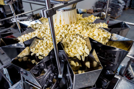 Vertical multi-head weigher packaging machine snacks and chips in a factoryの写真素材