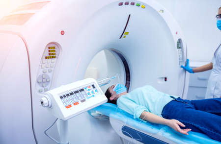 Radiologist with a female patient in the room of computed tomographyの写真素材