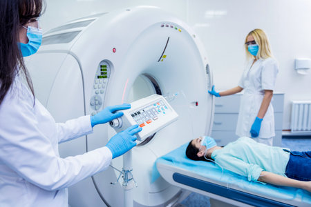 Radiologist with a female patient in the room of computed tomographyの写真素材