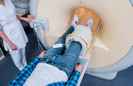 Radiologist prepares the patient for an MRI knee examination