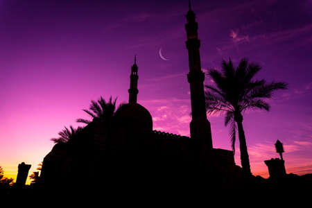 Beautiful large Islamic mosque at the sunset sky backgroundの写真素材