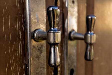 metal rustic door handles at wooden brown doorsの写真素材