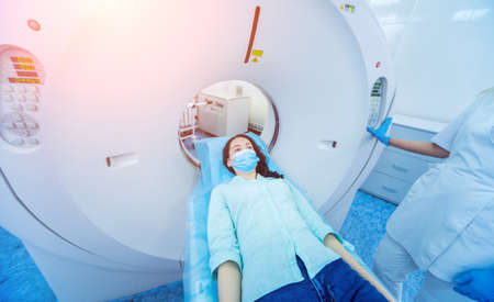 Radiologist with a female patient in the room of computed tomographyの写真素材
