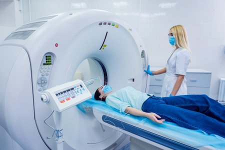 Radiologist with a female patient in the room of computed tomographyの写真素材