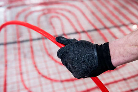 Pipefitter install system of underfloor heating system at homeの写真素材