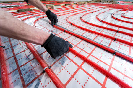 Pipefitter install system of underfloor heating system at homeの写真素材