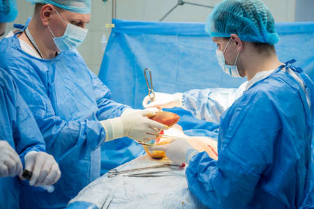 Breast augmentation under the guidance surgeons team in surgical operating room.の写真素材