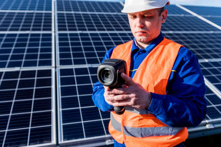 Inspector examination of photovoltaic modules using a thermal imaging cameraの写真素材