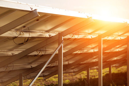 Back view of photovoltaic solar panels on sunset background