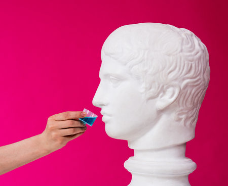 Beautiful girl proposes mouthwash for antique statueの写真素材