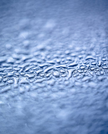 Many different drops of water on the metal surface