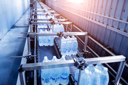 Modern strapping and transporting machine for packaging line at beverage plant.の写真素材