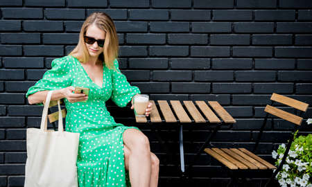 Young beautyful woman with linen eco bag on city background.の写真素材