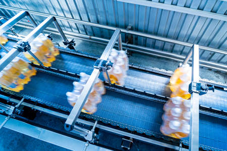 Modern strapping and transporting machine for packaging line at beverage plant.の写真素材