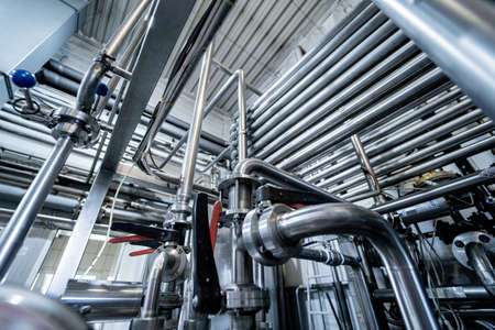 Modern interior of a beverage plant with barrels and pipesの写真素材