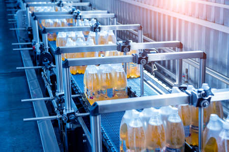 Modern strapping and transporting machine for packaging line at beverage plant.の写真素材