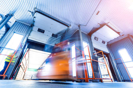 Forklift loader working at beverages plant warehouseの写真素材