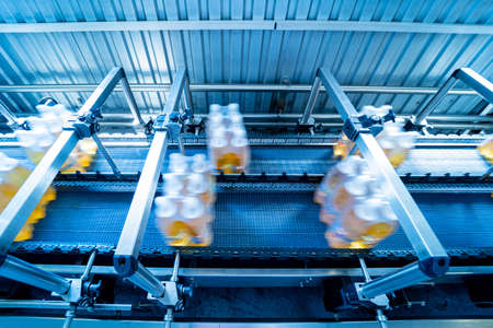 Modern strapping and transporting machine for packaging line at beverage plant.の写真素材
