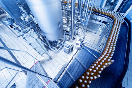 Conveyor belt with bottles for juice or water at a modern beverage plant