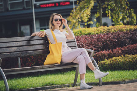 Young beautiful woman with linen eco bag on city background.の写真素材