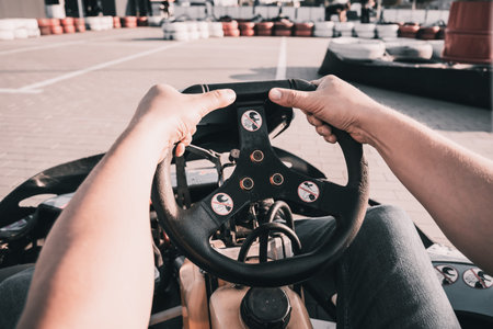 A young man drives a go kart at circuit