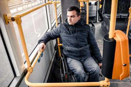 Person with a physical disability inside public transport with an accessible ramp.の写真素材