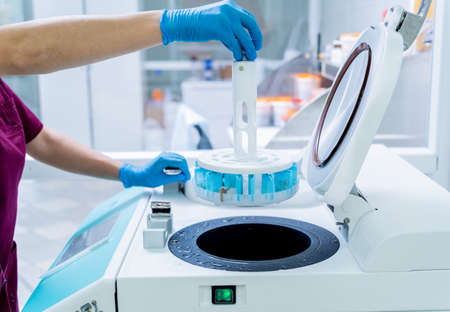 Laboratory assistant works with microwave hybrid tissue processor at the modern laboratory.の写真素材