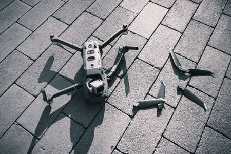Crashed drone lays on the ground and damagedの写真素材