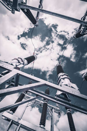 Construction of a power transmission substation on a background of grey skyの写真素材