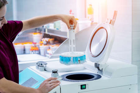 Laboratory assistant works with microwave hybrid tissue processor at the modern laboratory.の写真素材