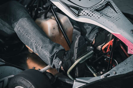 A young man drives a go kart at circuitの写真素材