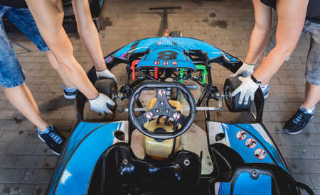 The mechanic go kart racing service change the wheelsの写真素材