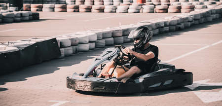 A young man drives a go kart at circuitの写真素材