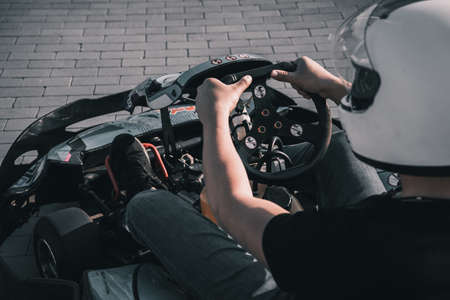 A young man drives a go kart at circuitの写真素材