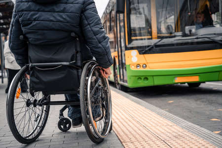 Person with a physical disability waiting for city transport with an accessible ramp.の写真素材