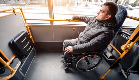 Person with a physical disability inside public transport with an accessible ramp.の写真素材