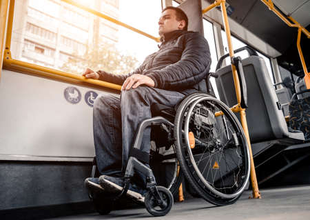 Person with a physical disability inside public transport with an accessible ramp.の写真素材