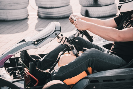 A young man drives a go kart at circuit