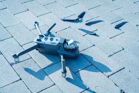 Crashed drone lays on the ground and damagedの写真素材